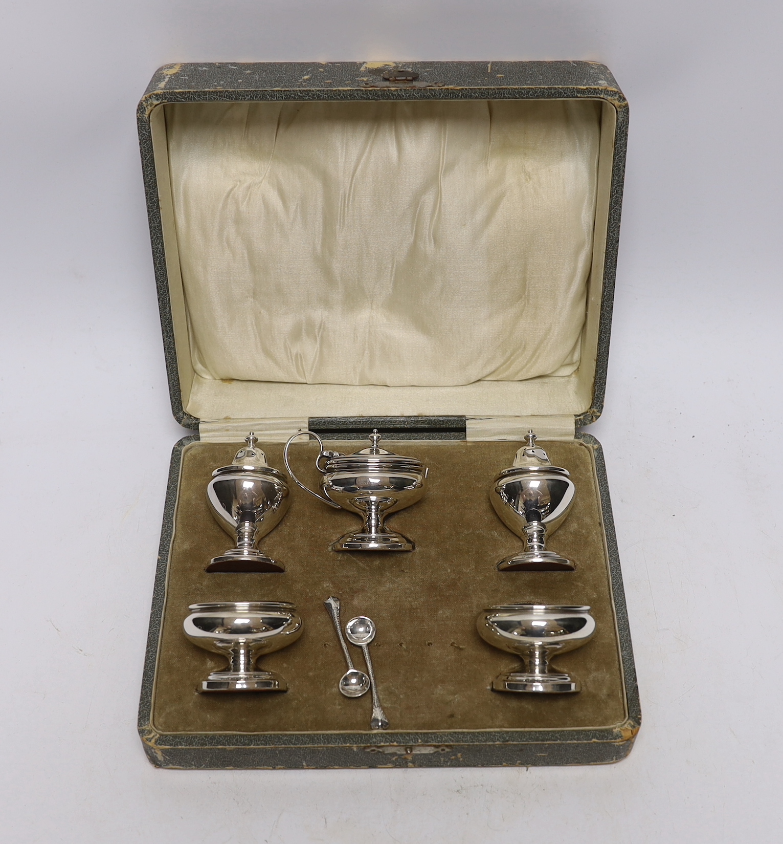 A cased George V silver five piece condiment set, Henry Clifford Davies, Birmingham, 1913 & 1917, with two associated plated spoons.